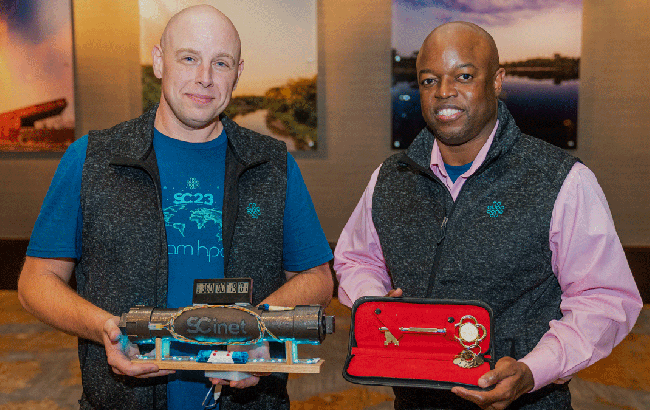 Hans Addleman and Dorian C. Arnold holding the proverbial keys to the SC23 conference.