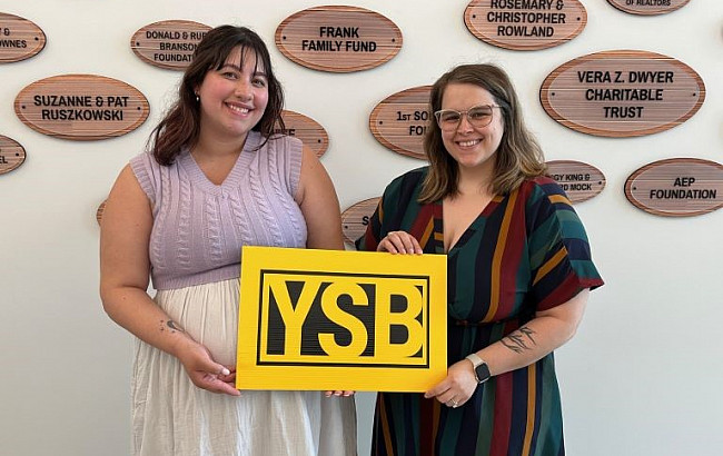 From left: Desiree Brewer and Nia Parillo  holding a yellow block with the letters YSB