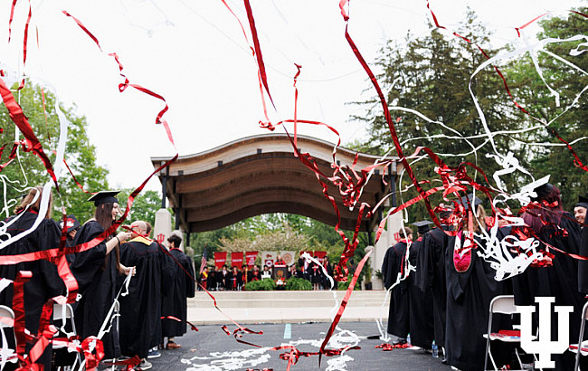 A roofed pavilion with graduates and confetti