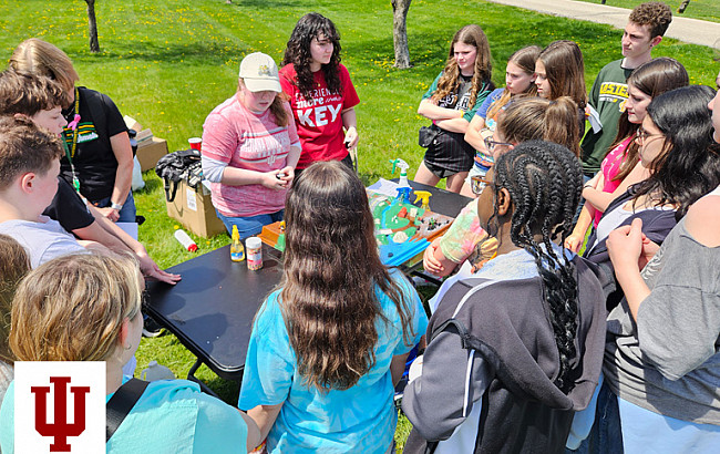 A group of people gather around a table