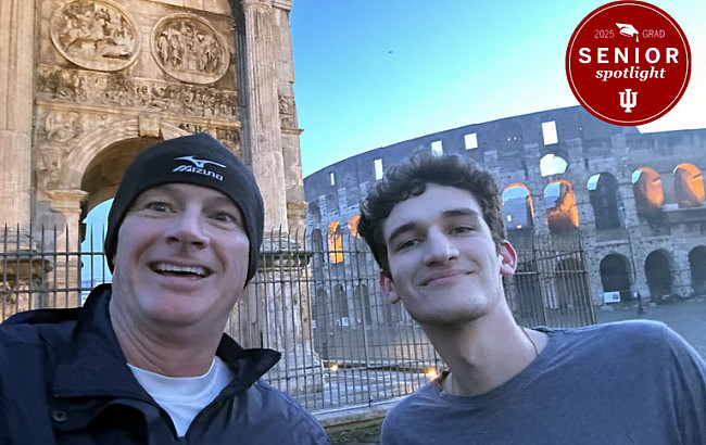 Two men pose for a selfie in front of Italian architecture