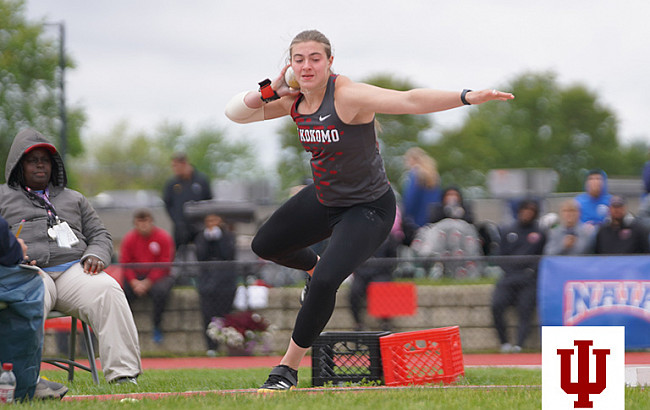 A woman throws a shot put