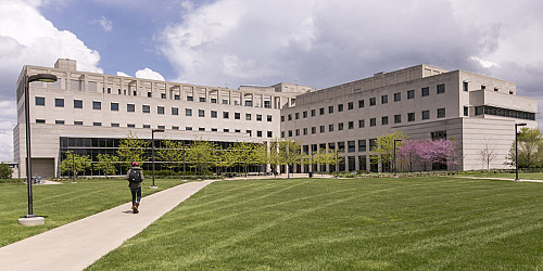 A picture of a student walking into a building