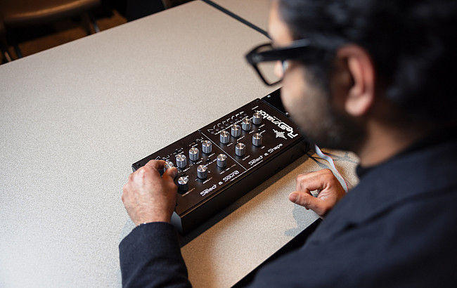 Harry Chaubey poses for a photograph with the resynator, a music synthesizer.