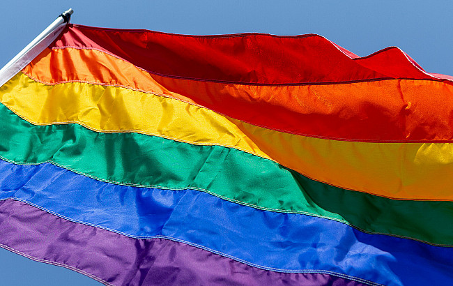 A pride flag flying in the wind