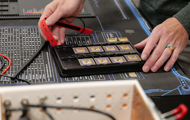 Pair of hands working with multiple microchips