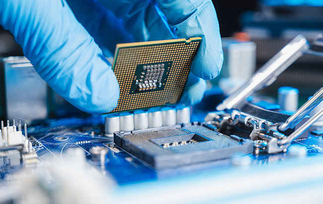 the technician laying CPU in the motherboard socket