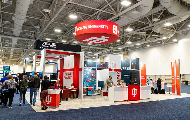 An IU branded exhibit in a large conference hall