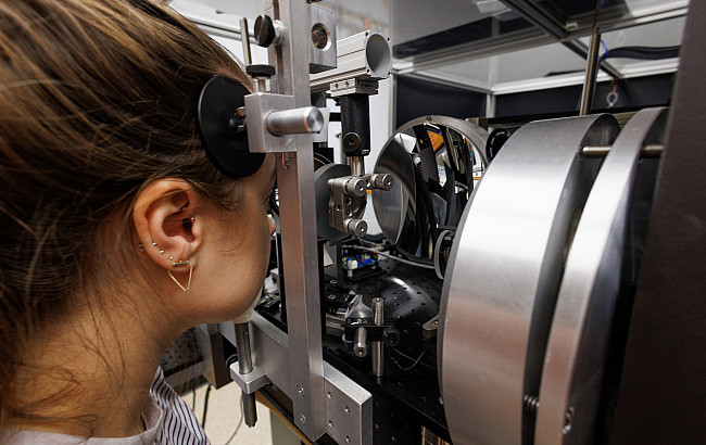 A woman looks into an eye scanning device