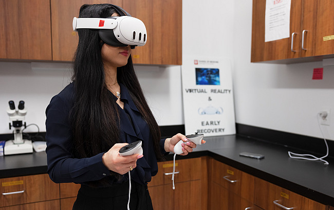 A woman uses a VR headset in a lab