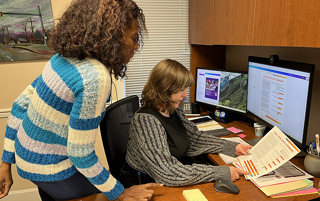 Wunmi Odufuye and Holly Gavin look at data on a computer