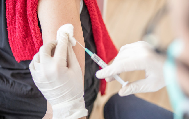 A woman receives a COVID-19 vaccine booster.