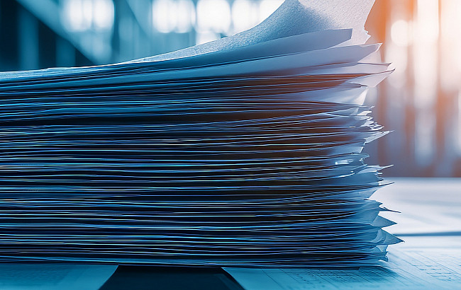 A stack of papers laying on a table.