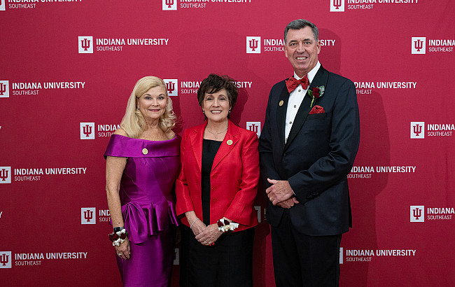 Three people posing in front of an IU Southeast backdrop