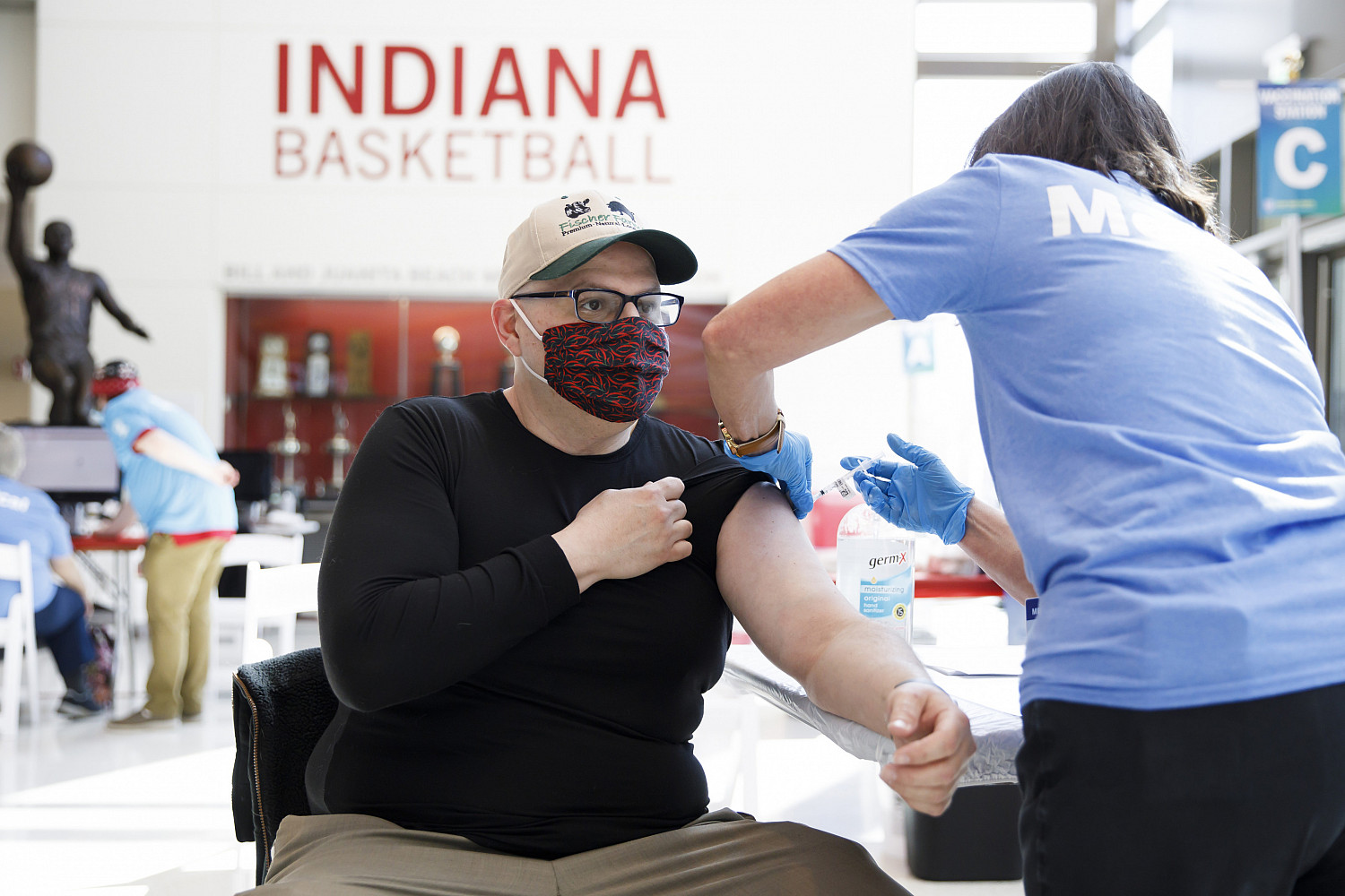 Omar Alani, 48, an IU Dining assistant manager, is the first person to receive a COVID-19 vaccine inside the new vaccination site in the ...