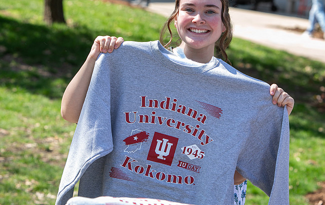 Student holds up an IU Kokomo sweatshirt