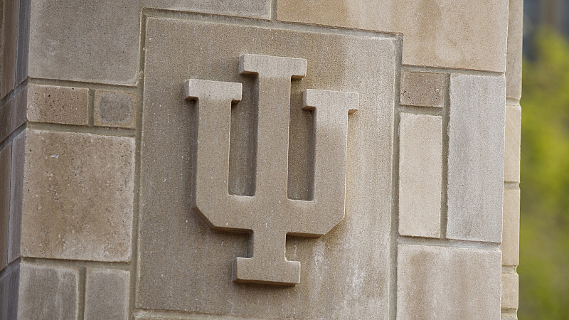 An IU trident adorns a limestone gate outside the Indiana Memorial Union at IU Bloomington.