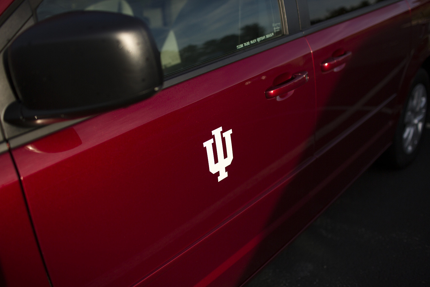 An IU logo adorns the door of a rental vehicle on Tuesday, Sept. 20, 2016, at Fleet Services.