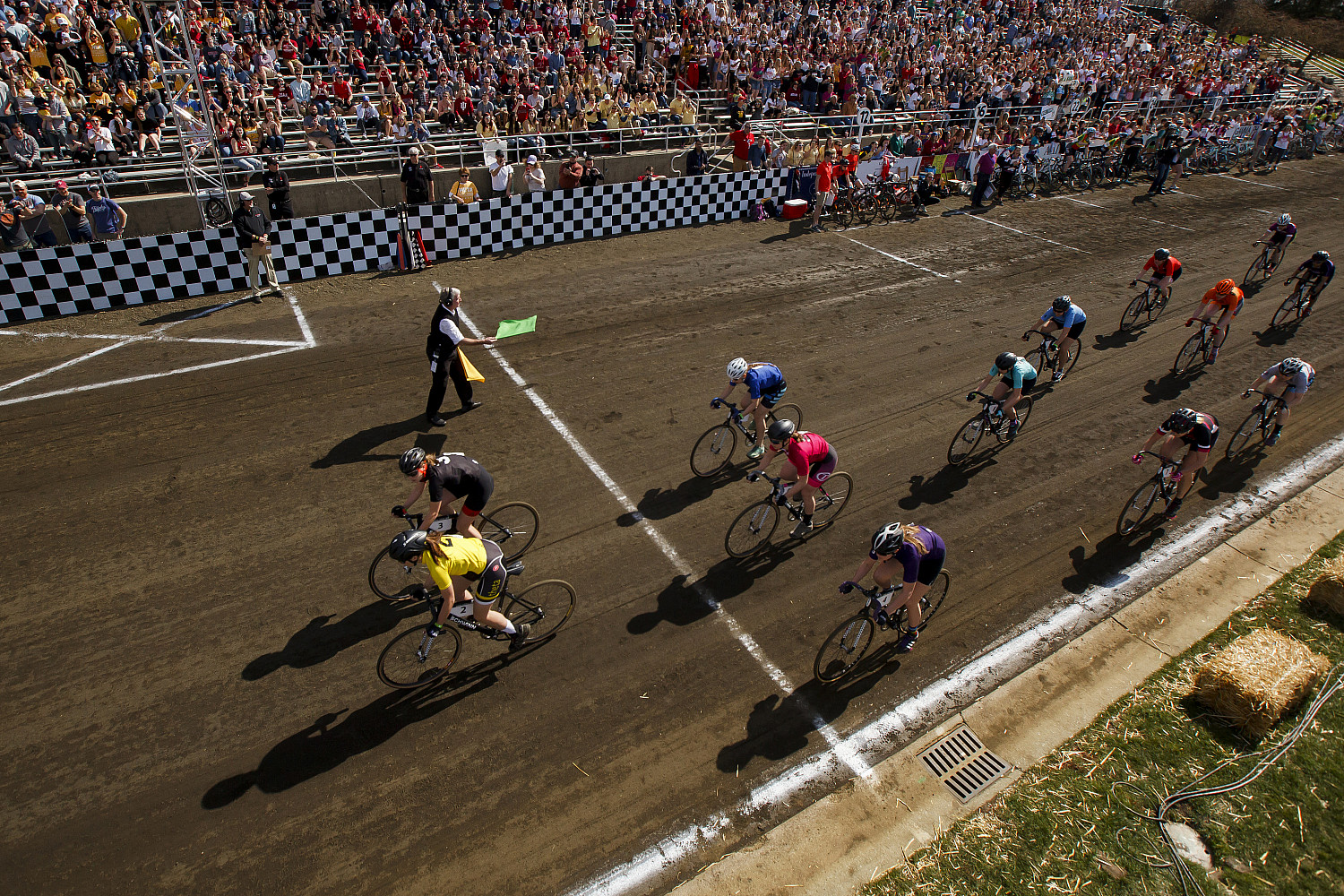Chap Blackwell IV waves the green flag to start the Women's Little 500 at Bill Armstrong Stadium on April 20, 2018. Photo by James Broshe...