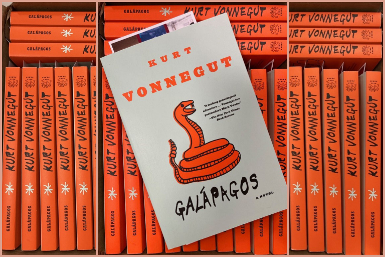 A stack of paperbacks supports a single copy on top showing the title, Galapagos by Kurt Vonnegut.