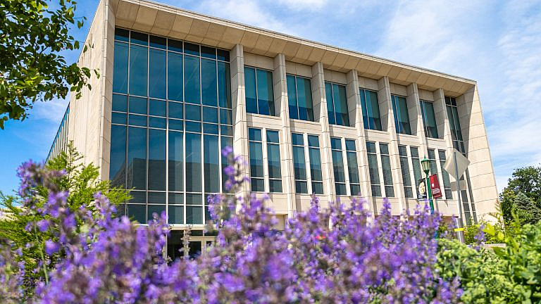 Exterior of the O'Neill School with flowers blooming in front