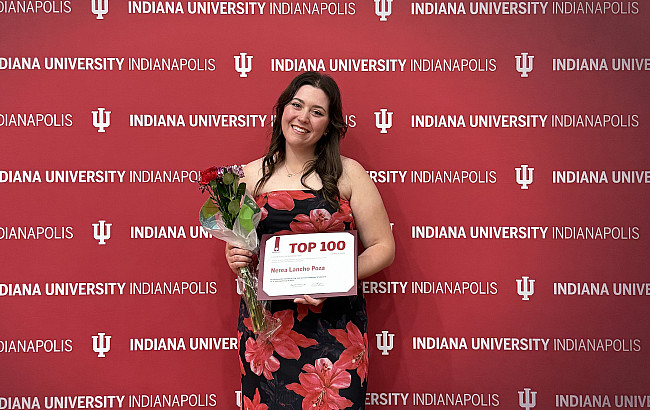 Lancho Poza holds her recognition as one of the Top 100 Student