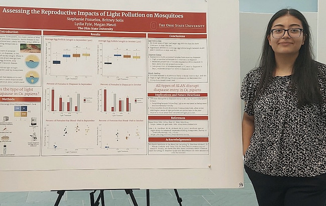 Biomedical Informatics student Stephanie Pozuelos stands next to her research poster