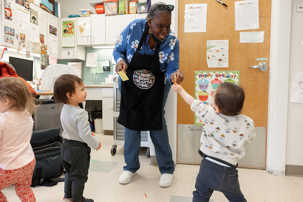 Karen Crawford, a teacher at the Center for Young Children at IUPUI, hands children snacks. Photo by Liz Kaye, Indiana University