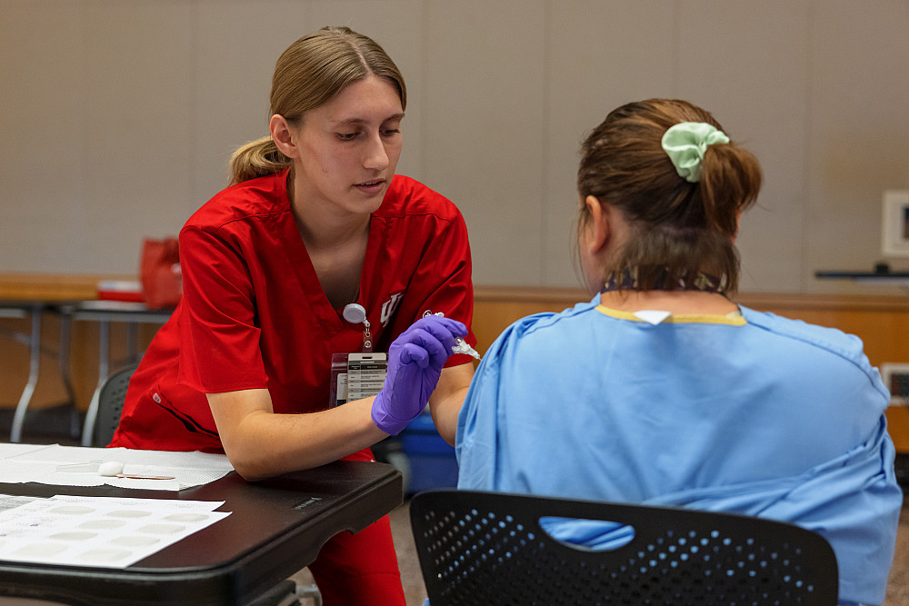 A health care professional gives a person a vaccine.