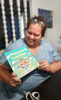 Christina McKee holds a copy of Postcards from Papa.