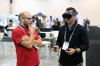 A man talks to someone wearing a virtual reality headset. Photo by Justin Casterline, Indiana University