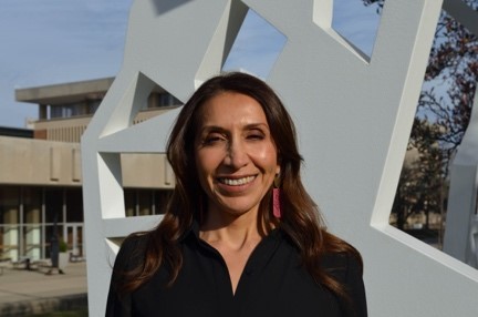 Headshot of Teresa Sosa standing in front of a white sculpture