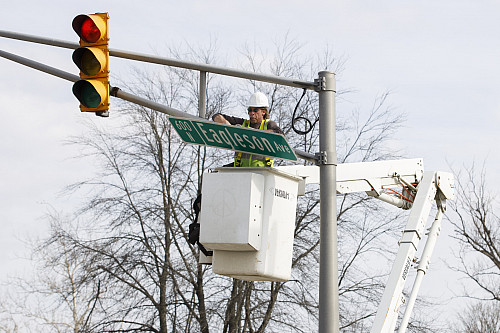 A City of Bloomington worker installs an Eagleson Avenue sign at the intersection with Law Lane at Indiana University Bloomington on Tues...