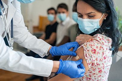 Vaccination center Injecting COVID-19 vaccine into patient's arm