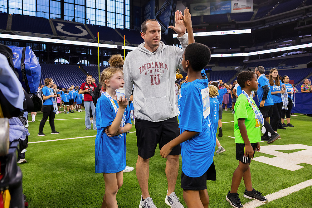 Jake Windsor and a student high five inside of Lucas Oil Stadium