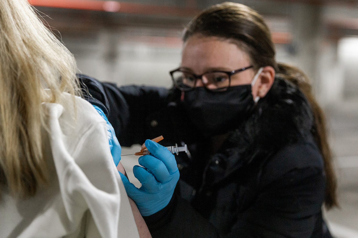 A staff member receives a flu shot