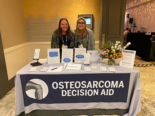 Janet Panoch, left, and Sabria Abufares standing behind a conference table