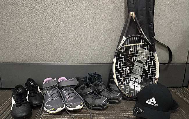 Donated sneakers, a tennis racket and a hat