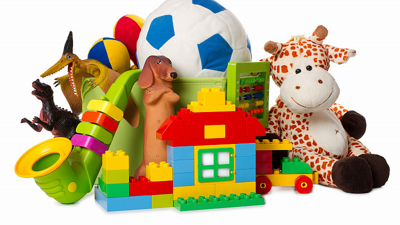 Group of colorful toys including a stuffed giraffe and a soccer ball